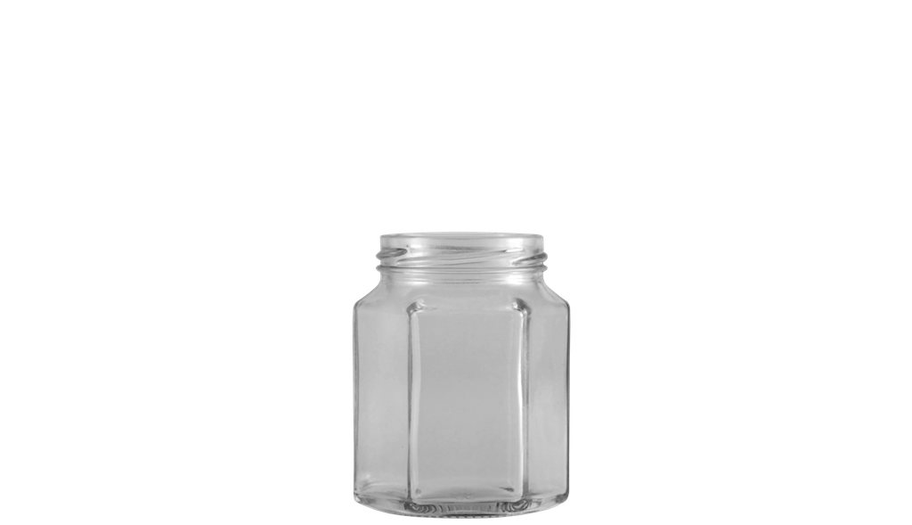 Envase de vidrio transparente, con base hexagonal y recto en sus aristas hasta su cuello, formato de poca capacidad.